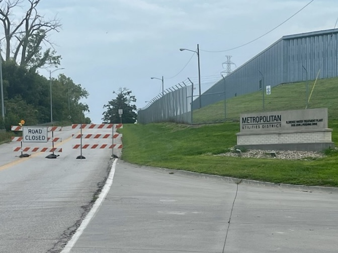 M.U.D. sign outside Florence Water Treatment Plant. Next to it stands a road closed sign.