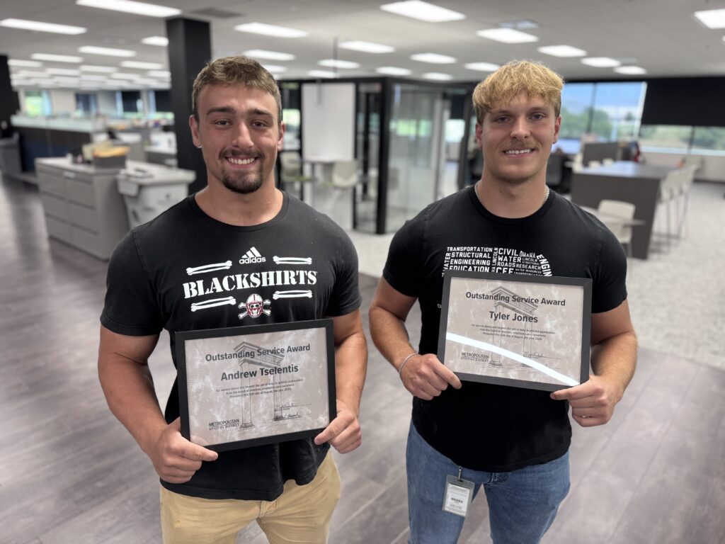Two M.U.D. employees pose with their Outstanding Service Awards