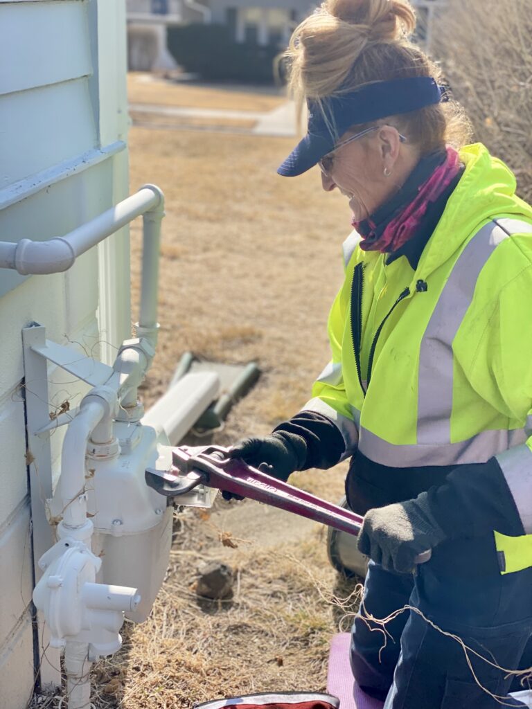 Utility worker performs maintenance on residential natural gas equipment